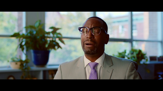 Video Reference N2: Forehead, Glasses, Plant, Flowerpot, Vision care, Window, Houseplant, Tie, Dress shirt, Suit
