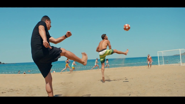 Video Reference N1: Sky, Shorts, Water, Sports equipment, People on beach, Beach, Trunks, Ball, Gesture, Net sports