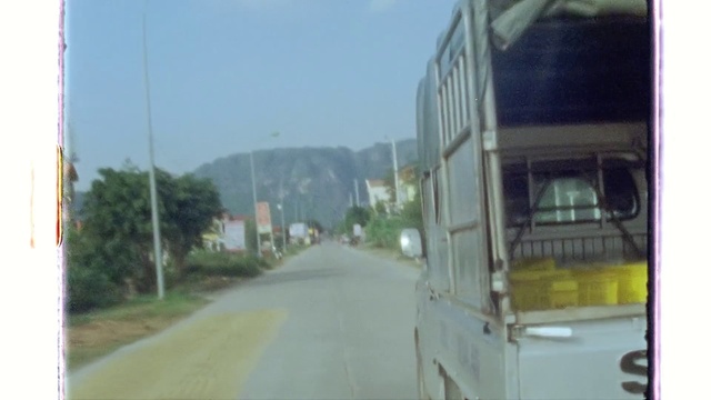 Video Reference N2: Sky, Bus, Vehicle, Automotive lighting, Automotive tire, Motor vehicle, Asphalt, Plant, Road surface, Mode of transport