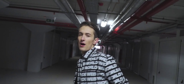 Video Reference N8: Flash photography, Dress shirt, Gesture, Audio equipment, Microphone, T-shirt, Entertainment, Event, Street fashion, Darkness