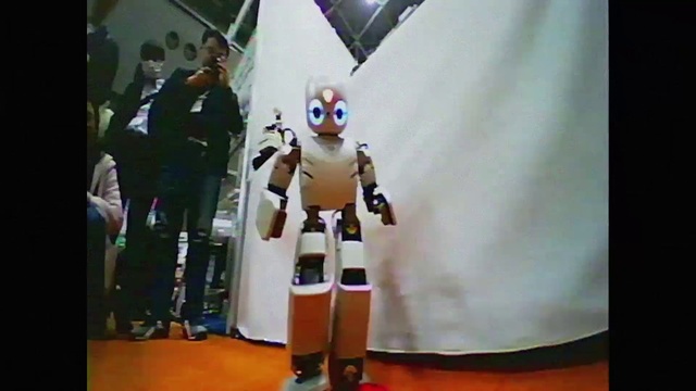 Video Reference N5: Toy, Technology, Event, Machine, Fashion design, Flooring, Carmine, Collectable, Display device, Anime