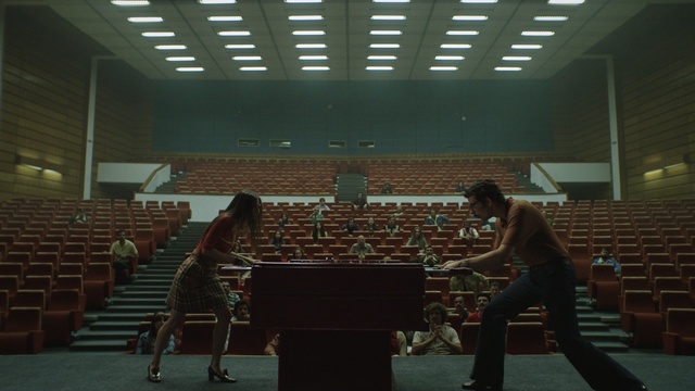 Video Reference N3: Human, Standing, Chair, Wood, Table, Event, Leisure, Hall, Flooring, Room
