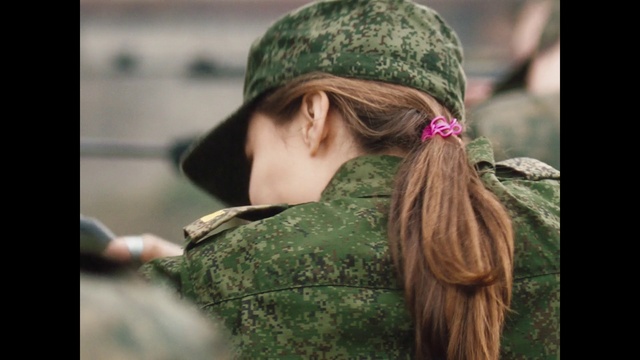 Video Reference N7: Hair, Outerwear, People in nature, Street fashion, Neck, Happy, Military camouflage, Headgear, Cap, Grass