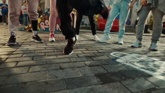 Video Reference N2: Footwear, Trousers, Shoe, Leg, Road surface, Thigh, Street fashion, Interaction, Sneakers, Public space