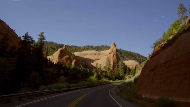 Video Reference N2: Sky, Plant, Plant community, Ecoregion, Infrastructure, Mountain, Tree, Road surface, Asphalt, Bedrock