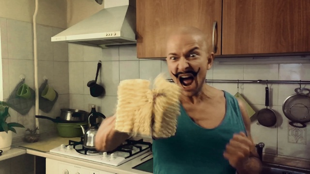 Video Reference N4: Smile, Chin, Hand, Kitchen appliance, Jaw, Kitchen, Countertop, Cabinetry, Gesture, Houseplant