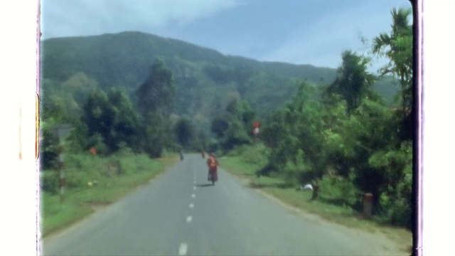 Video Reference N3: Sky, Plant, Mountain, Tree, Vehicle, Road surface, Cloud, Asphalt, Mode of transport, Land lot