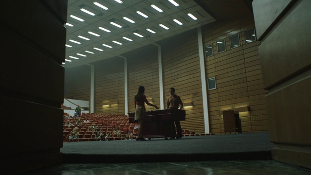 Video Reference N2: Chair, Building, Musician, Hall, Flooring, Musical instrument, Art, Wood, Event, Ceiling