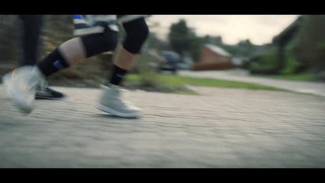Video Reference N6: Shorts, Sports equipment, Leg, Human body, Asphalt, Flash photography, Sports gear, Grass, Rolling, Knee
