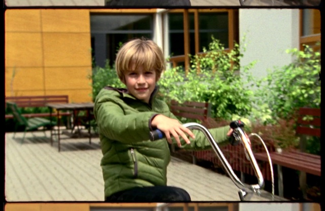 Video Reference N0: Plant, Smile, Window, Jacket, Bicycle handlebar, Grass, Leisure, Toddler, Recreation, Motor vehicle