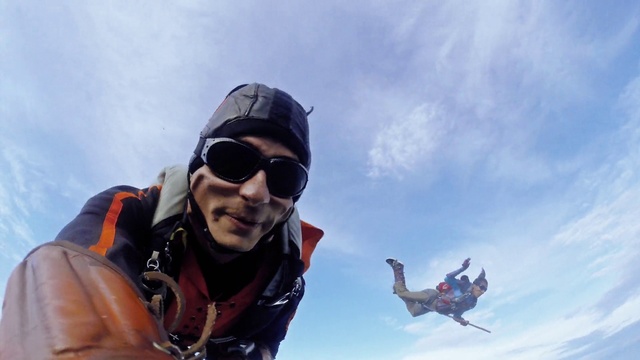 Video Reference N21: Tandem skydiving, Glasses, Cloud, Sky, Goggles, Glove, Sunglasses, Helmet, Vision care, Eyewear