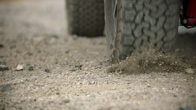 Video Reference N4: Automotive tire, Road surface, Grey, Asphalt, Tread, Grass, Wood, Trunk, Automotive wheel system, Human leg