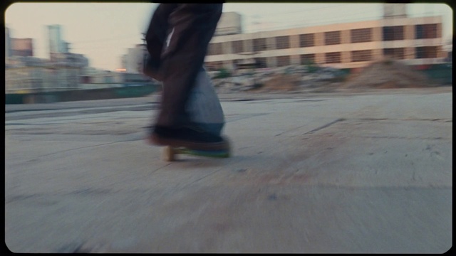 Video Reference N11: Asphalt, Road surface, Street fashion, Knee, Rolling, Floor, Flooring, Wood, Tints and shades, Skateboarder