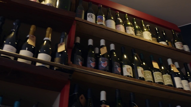 Video Reference N19: Bottle, Furniture, Shelf, Drinking establishment, Drinkware, Wine, Shelving, Glass bottle, Wine cellar, Winery