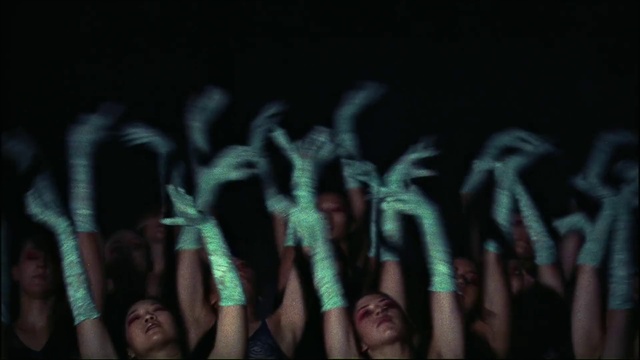 Video Reference N3: Human body, Gesture, Font, Adaptation, Event, Nail, Darkness, Electric blue, Performing arts, Crowd