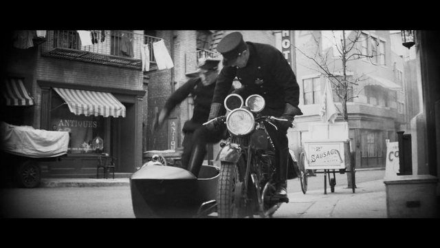 Video Reference N3: Automotive lighting, Human, Tire, Motor vehicle, Flash photography, Hat, Motorcycle, Black-and-white, Style, Wheel