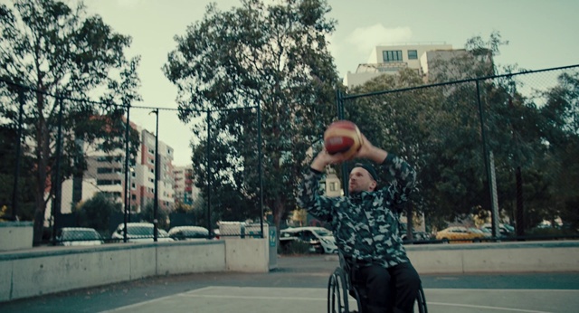 Video Reference N4: Sky, Tire, Building, Wheel, Tree, Streetball, Hat, Street fashion, Wheelchair, Cool