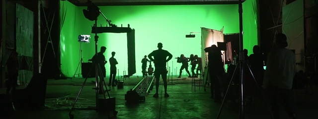 Video Reference N5: Green, Film studio, Human, Entertainment, Standing, Musician, Performing arts, Music, Tripod, Stage