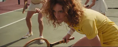 A close-up of a tennis player in warm light